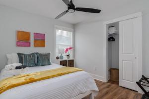 a bedroom with a bed with a ceiling fan at Be A Nomad - Perfect for groups - Brand New in Jacksonville Beach +19 photos