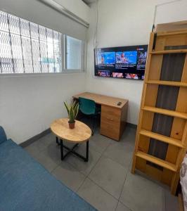 a room with a desk and a table and a deskictericter at Apartamento zona 1 in Guatemala