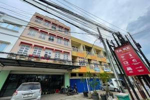 a building with a car parked in front of it at Take Guesthouse 1 in Jambi