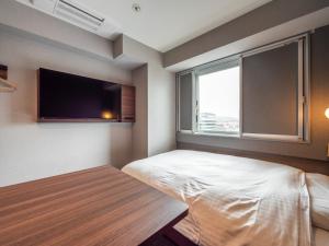 Postel nebo postele na pokoji v ubytování Super Hotel Premier JR Nara Eki