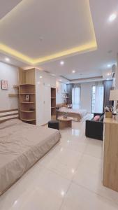 a bedroom with a bed and a living room at Ez mart and stay in Hai Phong