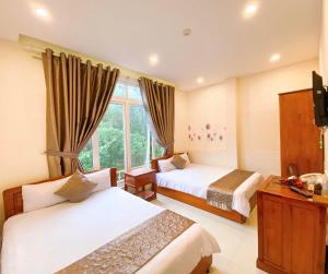 Postel nebo postele na pokoji v ubytování Hotel Phạm Duy