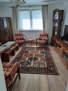 a living room with two chairs and a rug at 75 m2 Apartment - Private House in Rumia