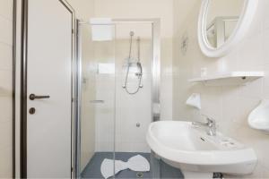 a white bathroom with a shower and a sink at Hotel Marea con Piscina NUOVA GESTIONE in Cattolica +21 photos