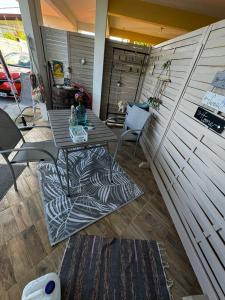 a patio with a table and chairs in a room at SWEET PARADISE STUDIO à 10 mn du centre en voiture in Fort-de-France