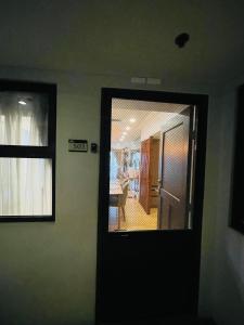 a door with a mirror in a room at KAMALA 503 ACACIA ESTATE TAGUIG CITY in Manila