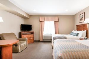 a hotel room with two beds and a television at Candlewood Suites LAX Hawthorne, an IHG Hotel in Hawthorne