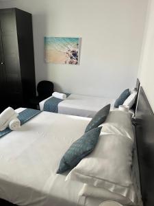 a hotel room with two beds with pillows at Hotel St Leonards in Sydney
