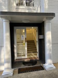 an entrance to a building with columns and a staircase at Hotel St Leonards in Sydney