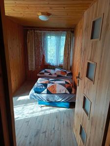a bedroom with two beds and a window and a door at Noclegi u Ewusi 2 in Januszowice