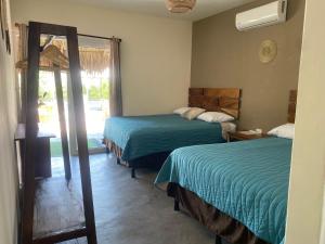 Postel nebo postele na pokoji v ubytování Gecko Hotel
