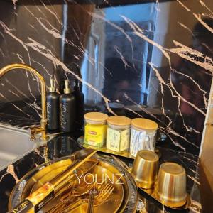 a kitchen counter with a sink and some spices at Younz Apartemen By Margonda Residence 2 in Pondokcina