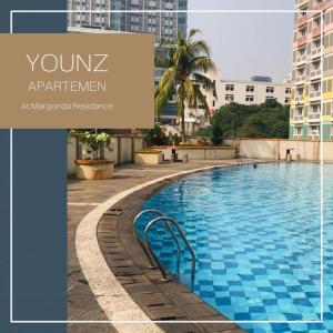 a swimming pool with a sign that reads your apartment at Younz Apartemen By Margonda Residence 2 in Pondokcina