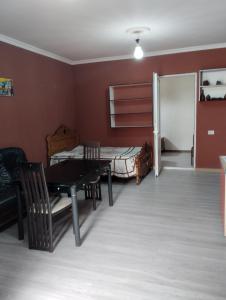 a living room with a table and a bed at Eka,s hotel in ortachala in Tbilisi City