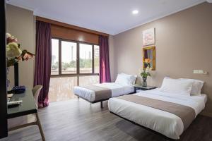 Postel nebo postele na pokoji v ubytování HOTEL 28 RAPID