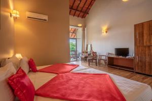 a bedroom with a large bed with red pillows at Lavendish Wild Wilpattu in Nochchiyagama +16 photos