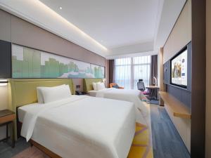 Voodi või voodid majutusasutuse Hampton by Hilton Shenzhen Longhua Qinghu toas
