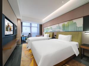 Voodi või voodid majutusasutuse Hampton by Hilton Shenzhen Longhua Qinghu toas