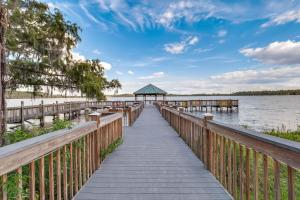 a wooden dock with a gazebo on the water at K and J Orlando in Orlando