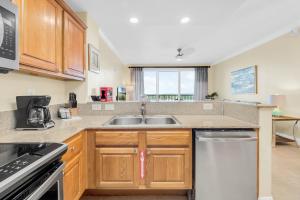 a kitchen with a sink and a stove at K and J Orlando in Orlando