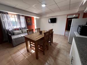 a living room with a table and chairs and a couch at Complejo de Cabaña con pileta CABLE A TIERRA Cabaña Blend in San Rafael