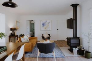 a living room with a couch and a wood stove at The Pines Barwon Heads in Connewarre