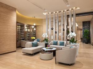 a lobby with couches and chairs and a table at CLASSYC Hotel in Hanoi