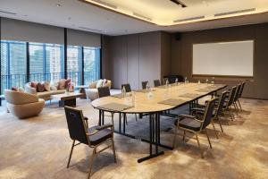 a conference room with a long table and chairs at Imperial Lexis Kuala Lumpur in Kuala Lumpur