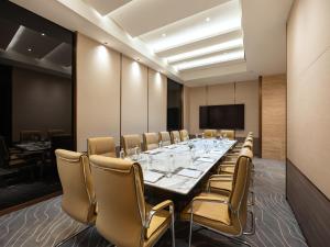 a conference room with a long table and chairs at CLASSYC Hotel in Hanoi