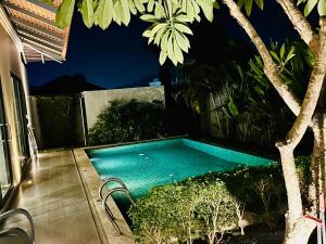 a swimming pool in the backyard of a house at summer pool villa in Laguna Phuket