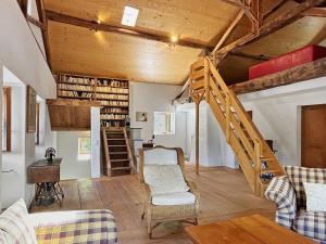 a living room with wooden ceilings and a staircase at La Maison du Bassin - Grand St Bernard - Orsieres in Orsières