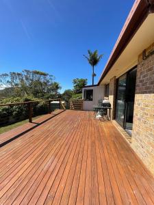 a wooden deck on the side of a house at Rocky in South West Rocks