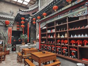 a store with wooden tables and red lanterns at Pingyao Harmony Hotel in Pingyao