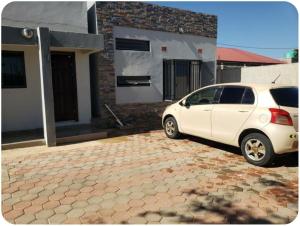 a white car parked in front of a house at The V Space in Lusaka