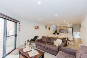 a living room with a couch and a table at Northstar 10 17 Kirwan Close in Jindabyne