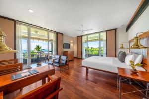 a living room with a white bed and a table at Heritance Ahungalla in Bentota