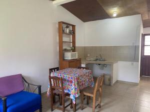 a room with a table and chairs and a kitchen at Kochian: Lugar donde se sueña in Zoquiapan