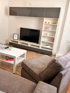 - un salon avec un canapé et une télévision dans l'établissement Schöne 2 Raum-Wohnung in Etgersleben, à Etgersleben