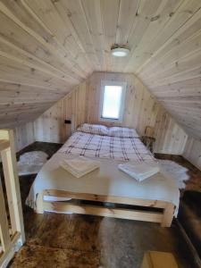 Leśne SPA في Lubień Kujawski: غرفة نوم بسرير في غرفة خشبية