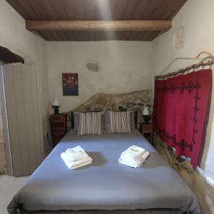 a bedroom with a large bed with towels on it at Casa Opuntia in Pappayiannádhes