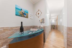 a bar in a room with a bottle of wine at Apulia Rooms Bari in Bari