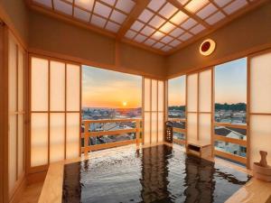 a room with a pool with a view of a city at Hotel New Wakasa in Nara