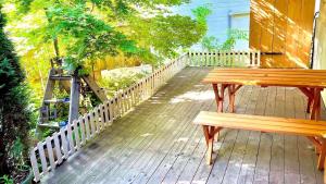 a wooden bench sitting on top of a deck at sato no mori KURA - Vacation STAY 20504v in Nagano