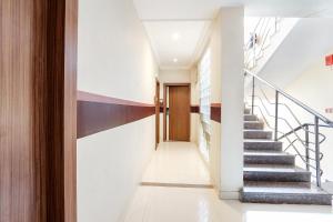 a hallway with stairs leading to a door at FabHotel Arastu in Hyderabad