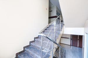 a staircase in a building with a metal railing at FabHotel Arastu in Hyderabad
