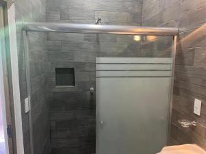 a shower with a glass door in a bathroom at La Casa de los Abuelos in Tequila +23 photos