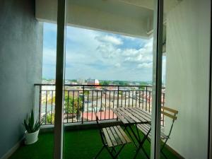 a balcony with a bench and a view of a city at The Majestic Ipoh Town - Mountain View in Ipoh