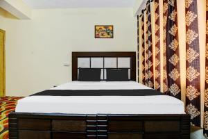 a bedroom with a large bed in a room at OYO Hotel Basera in Shimla