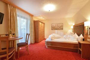 Krevet ili kreveti u jedinici u okviru objekta Hotel Garni Bavaria