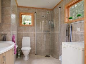 a bathroom with a shower and a toilet and a sink at 4 star holiday home in Sparreholm in Sparreholm +22 photos